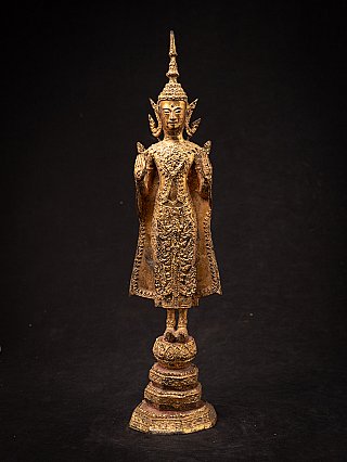 Thai bronze Buddha statue standing in Abhaya mudra, full front view on tiered base
