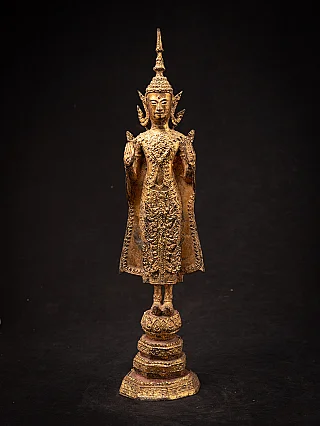 Thai bronze Buddha statue standing in Abhaya mudra, full front view on tiered base