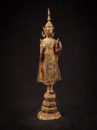 Thai bronze Buddha statue standing in Abhaya mudra, angled front view on pedestal