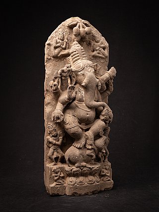 Ganesha carved in high relief on an Indian sandstone panel, full front view with arched top