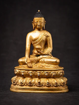 Nepali bronze Buddha statue seated on a lotus base, full-front view with varada mudra