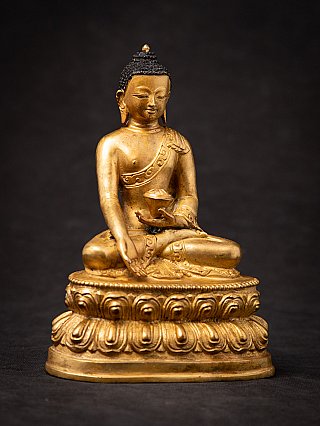 Nepali bronze Buddha statue seated, three-quarter right view with varada mudra