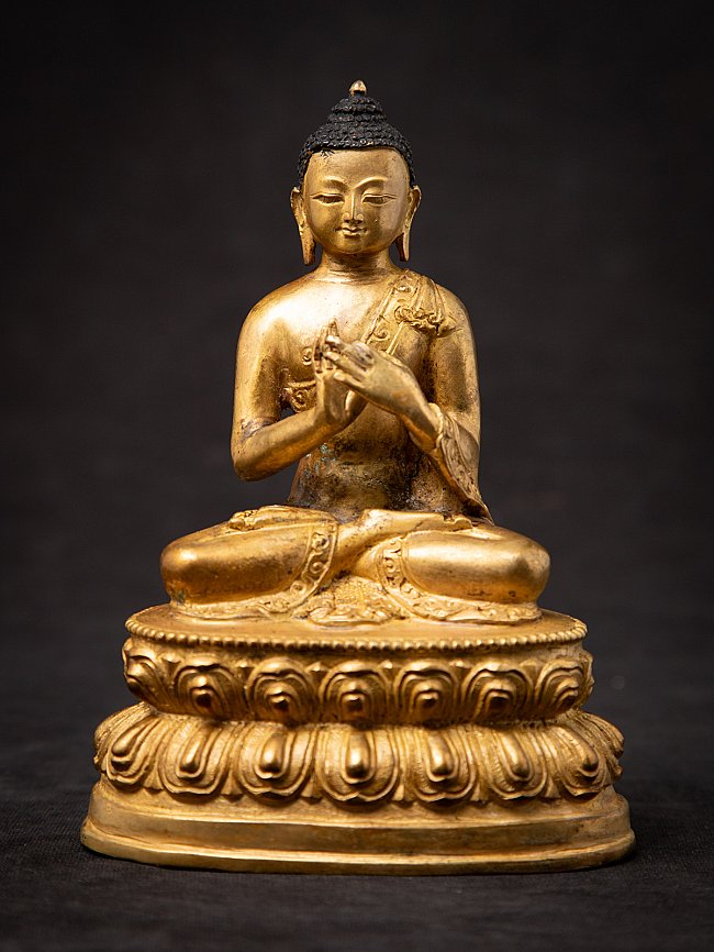 Nepali bronze Buddha statue seated on a lotus base, full front view, Dharmachakra mudra