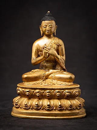 Nepali bronze Buddha statue seated on a lotus base, full front view, Dharmachakra mudra