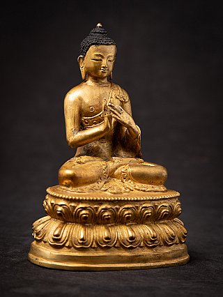 Nepali bronze Buddha statue on lotus base, three-quarter left view, Dharmachakra mudra