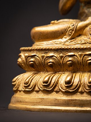 Lotus base close-up with layered petals and rim on the Nepali bronze Buddha statue