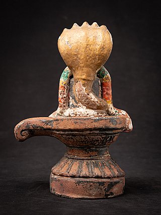 Shiva lingam on circular base, rear view showing the back of the cobra canopy