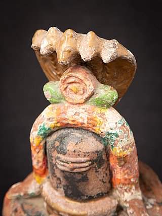 Detail of the cobra canopy above the Shiva lingam, showing worn edges and paint traces