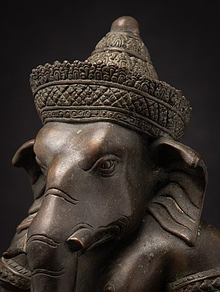 Bronze Ganesha head detail, angled view showing crown texture and ear
