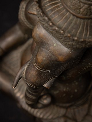 Top angled view of the bronze Ganesha head with trunk and headdress rim