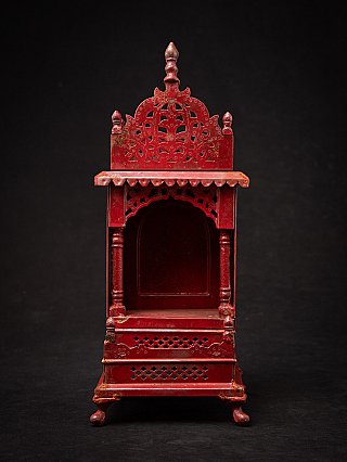 Nepali wooden shrine with arched opening and pierced base, full front view
