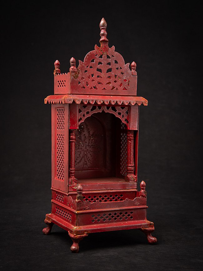 Nepali wooden shrine with open niche and pierced crest, three-quarter front view