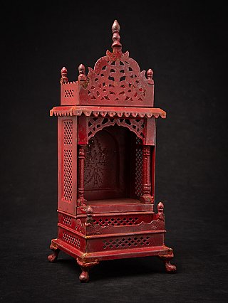Nepali wooden shrine with open niche and pierced crest, three-quarter front view