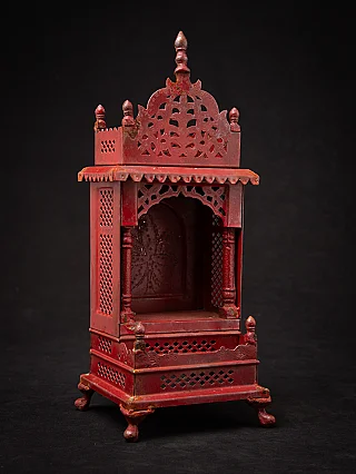 Nepali wooden shrine with open niche and pierced crest, three-quarter front view