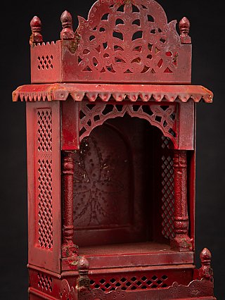 Front detail of the Nepali wooden shrine showing arch opening, posts and pierced crest