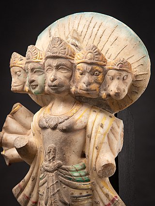 Angled close-up of the Panchamukhi Hanuman marble statue, emphasizing the five heads on the right