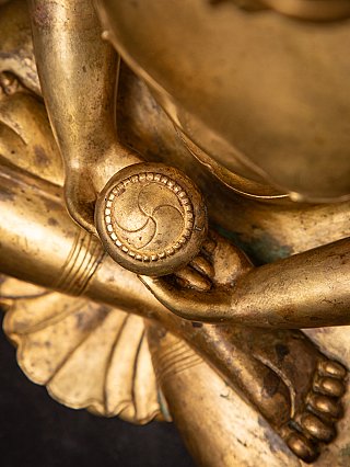 Top view detail of bowl in hands and lotus base on a Nepali gilded bronze Buddha