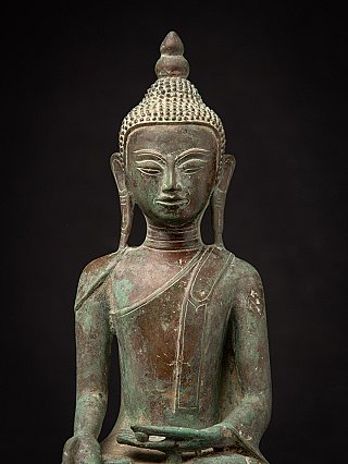Front upper-body view of the Burmese bronze Buddha statue showing face, torso and robe lines