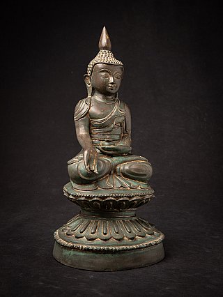 Bronze Burmese Buddha statue seated, angled front view with lotus base and patina