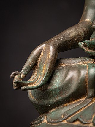 Varada mudra hand detail of the Burmese bronze Buddha near the knee