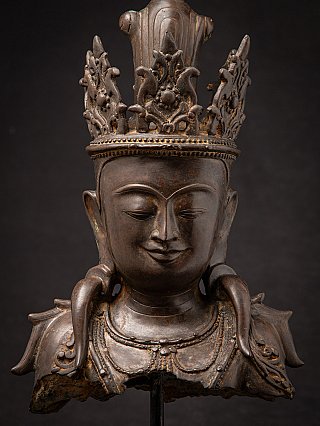 Frontal detail of Burmese bronze Buddha head with crown band and ear ornaments