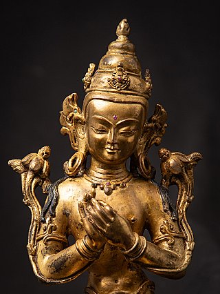 Face and hands close-up of the Nepali bronze Bodhisattva, dharmachakra mudra