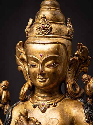 Face detail of the Nepali bronze Bodhisattva with inset stones and ear ornaments