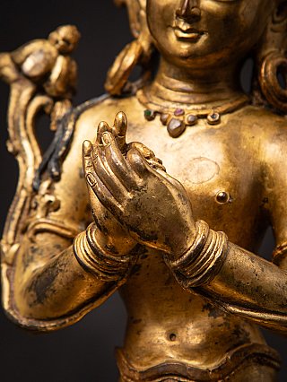 Hands detail of the Nepali bronze Bodhisattva showing dharmachakra mudra and bracelets