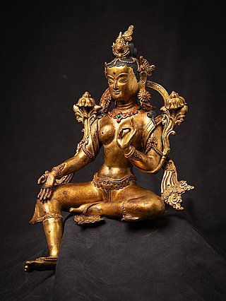 Green Tara bronze statue from Nepal, three-quarter view showing raised hand and inlaid necklace