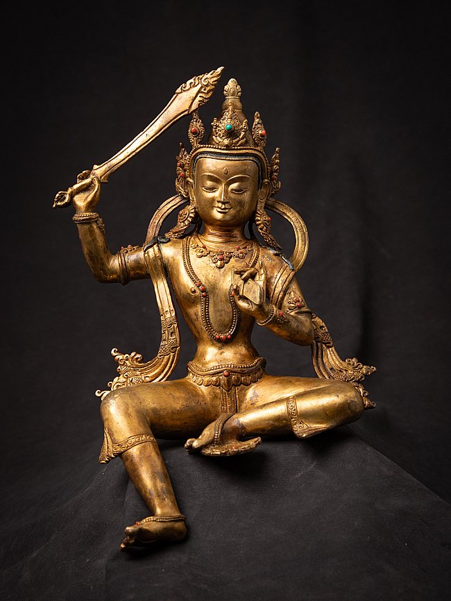 Nepali bronze Manjushri statue seated with raised sword and vitarka mudra, front view