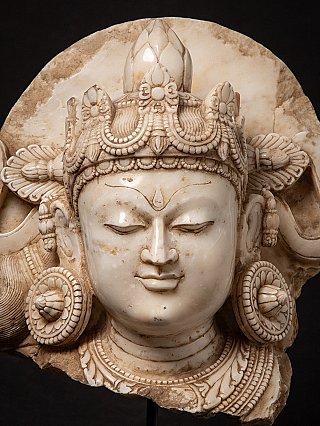 Front view of the antique marble Bodhisattva head, with symmetrical ear ornaments and crown