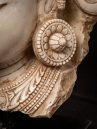 Detail of the round earring and neck ornament carving on the marble Bodhisattva head