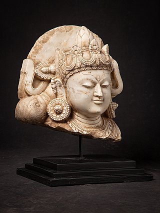 Antique marble Bodhisattva head in right three-quarter view, showing crown and neck ornament