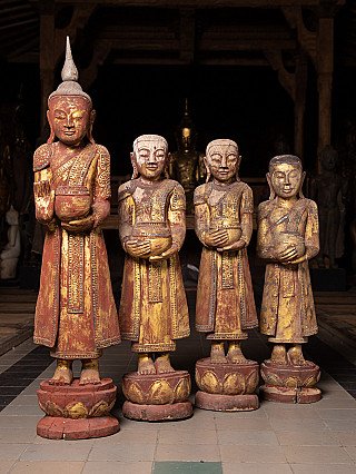 Burmese wooden Buddha statue with three monk statues, standing group front view