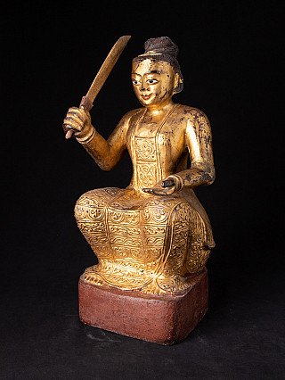 Burmese Nat statue in gilded wood, three-quarter view showing raised sword and open palm