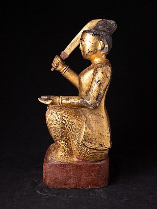 Antique Burmese Nat statue, side profile with sword held upright and incised robe patterns