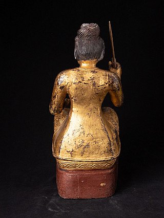 Seated Burmese Nat statue in gilded wood, rear view with topknot and worn gilding