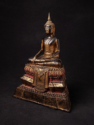 Bronze Buddha statue from Thailand in three-quarter view, showing the stepped base with red lacquer