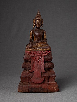Thai wooden Buddha statue in bhumisparsha mudra, seated on red painted base, full front view