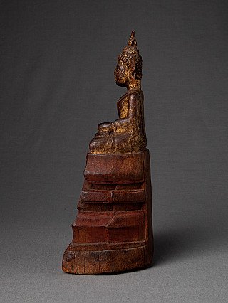 Thai wooden Buddha statue, seated, side profile showing the stepped base