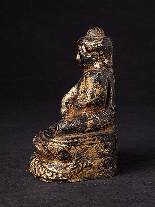 Wooden Buddha statue from Burma (Myanmar), left side profile showing head and layered base
