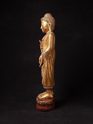 Stehende Buddha-Statue aus Holz aus Burma, linke Seitenansicht mit Gewandfalten
