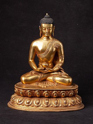 Nepali bronze Buddha statue seated on a lotus base, full front view with dhyana mudra and bowl