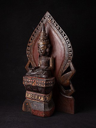 Wooden Mon Buddha statue with leaf-shaped aureole, three-quarter left view