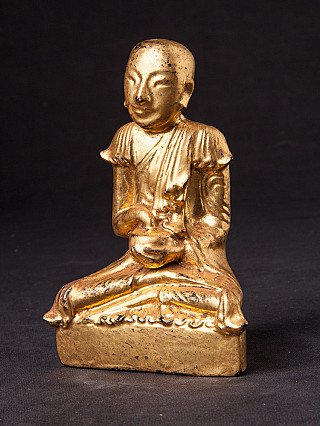 Burmese monk statue in lacquerware, seated on base, three-quarter left view