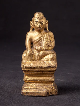Burmese wooden Buddha statue seated in bhumisparsha mudra, full front view