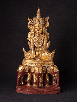 Crowned Burmese Buddha statue in wood on elephant base, full front view