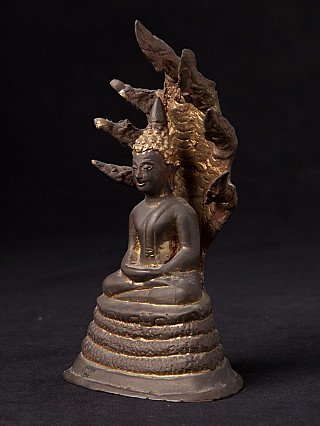 Thai bronze Buddha statue on Naga serpent, three-quarter left view