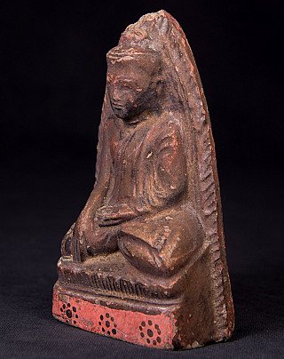 Buddha statue amulet from Burma, three-quarter view showing the red base and seated figure
