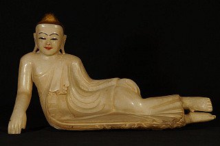 Reclining Buddha statue in marble from Myanmar, full view with painted face and gilded hair